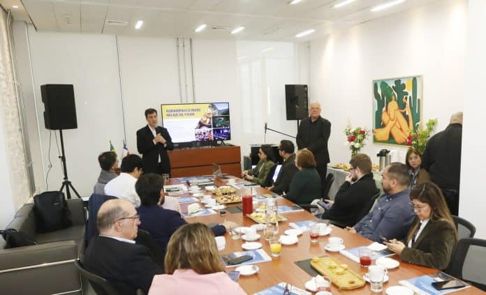 Apresentação de Florianópolis a jornalistas e operadoras de turismo em sala da Embaixada do Brasil em Santiago, no Chile, com participantes sentados à mesa